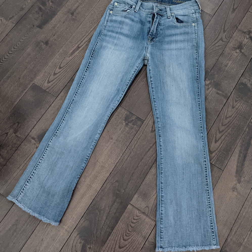 7 For All Mankind light wash denim jeans.